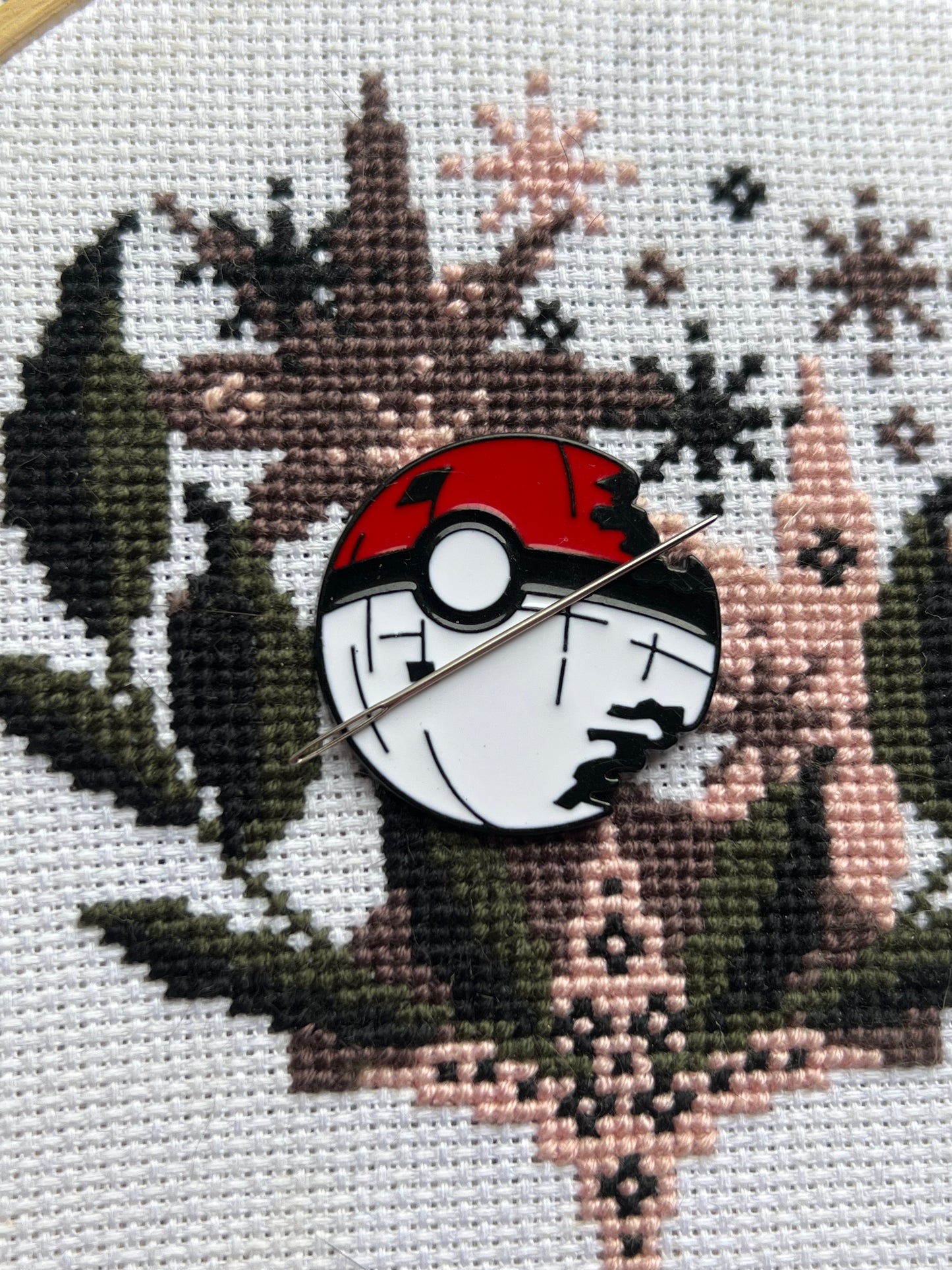 Poke ball needle minder