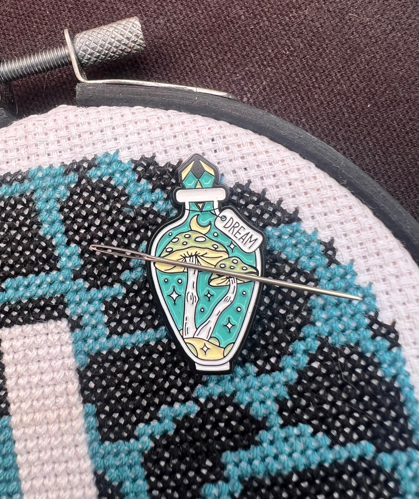 Teal potion magnetic needle minder