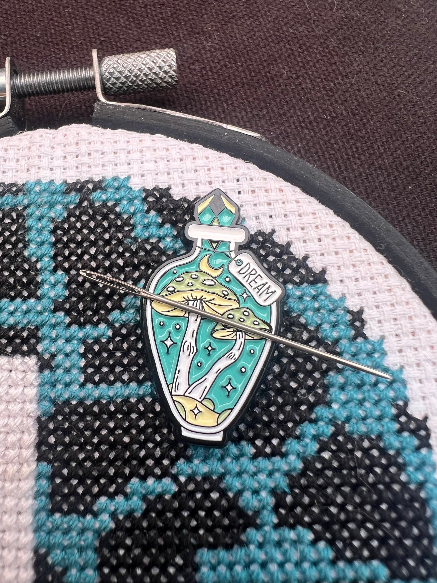 Teal potion magnetic needle minder